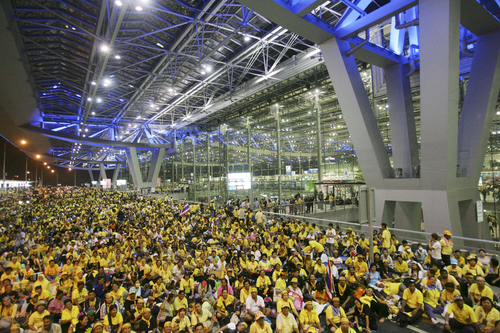 Anti government protesters sits in front of the departure terminal at Suvarnabhumi airport, Bangkok in the early hours of Wednesday Nov. 26, 2008
