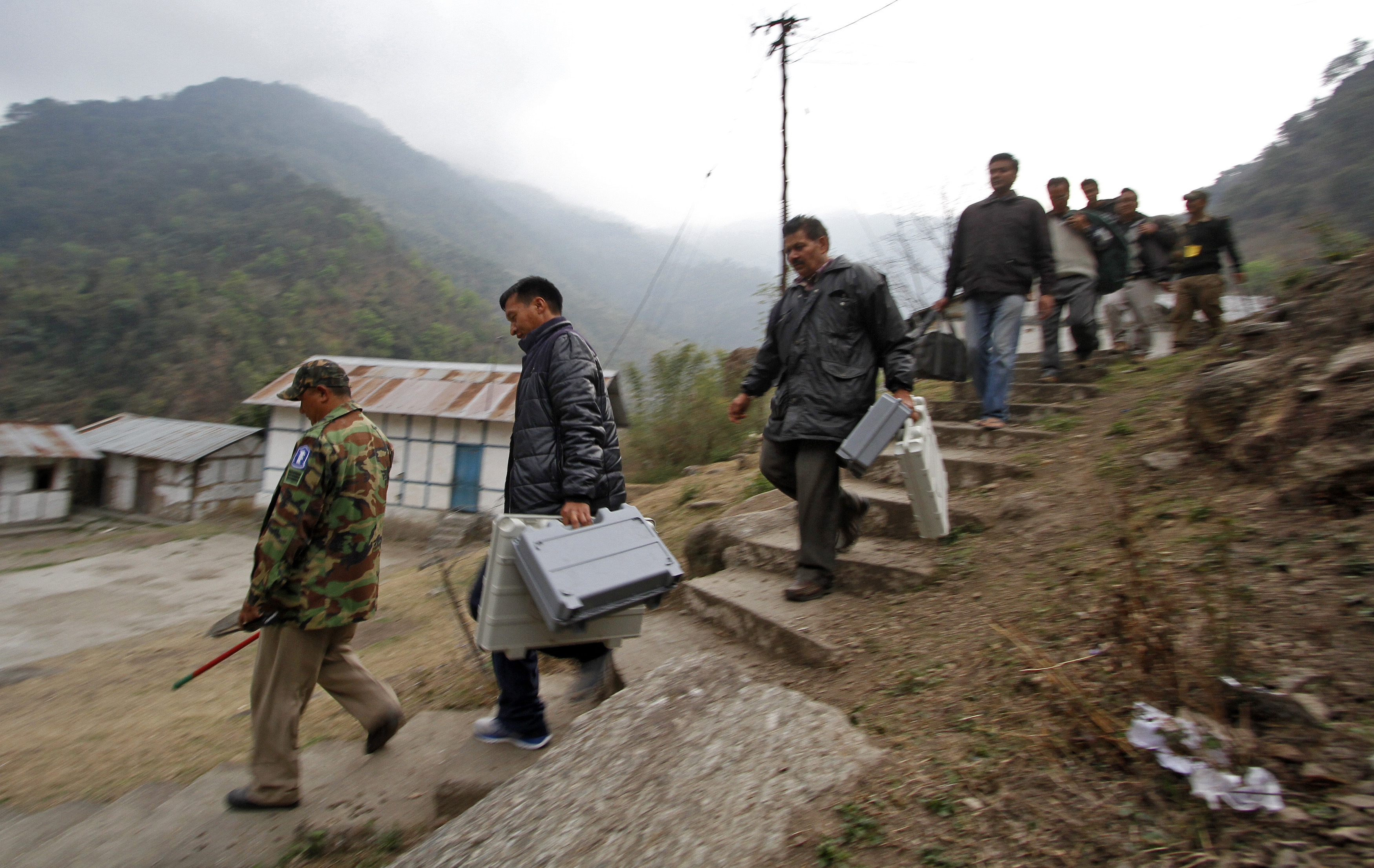 Electoral staff carry electronic voting machines (EVM) to a polling centre at Kaspi village, in the northeastern Indian state of Arunachal Pradesh April 8, 2014.