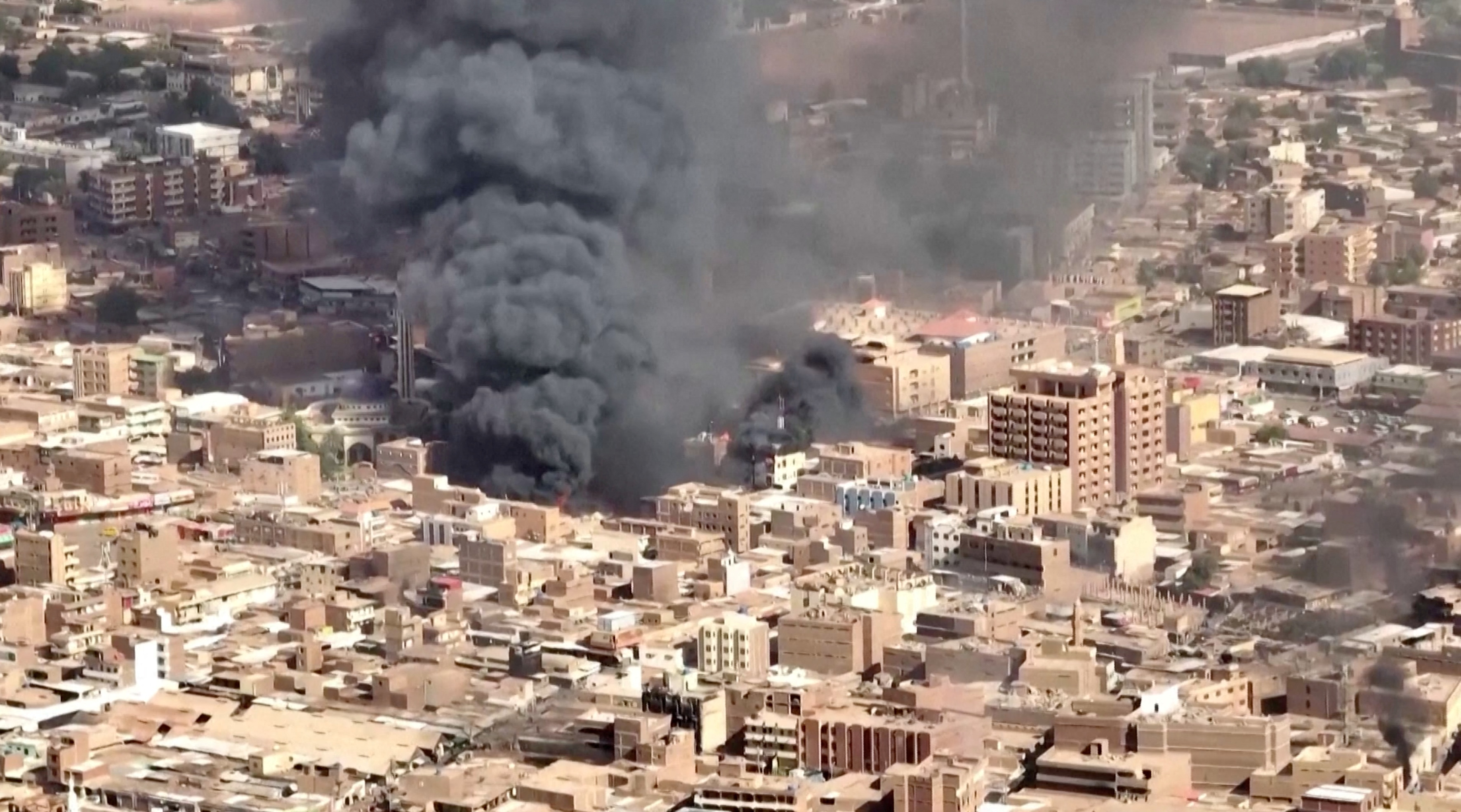 An aerial view of the black smoke and flames at a market in Omdurman, Khartoum North, Sudan