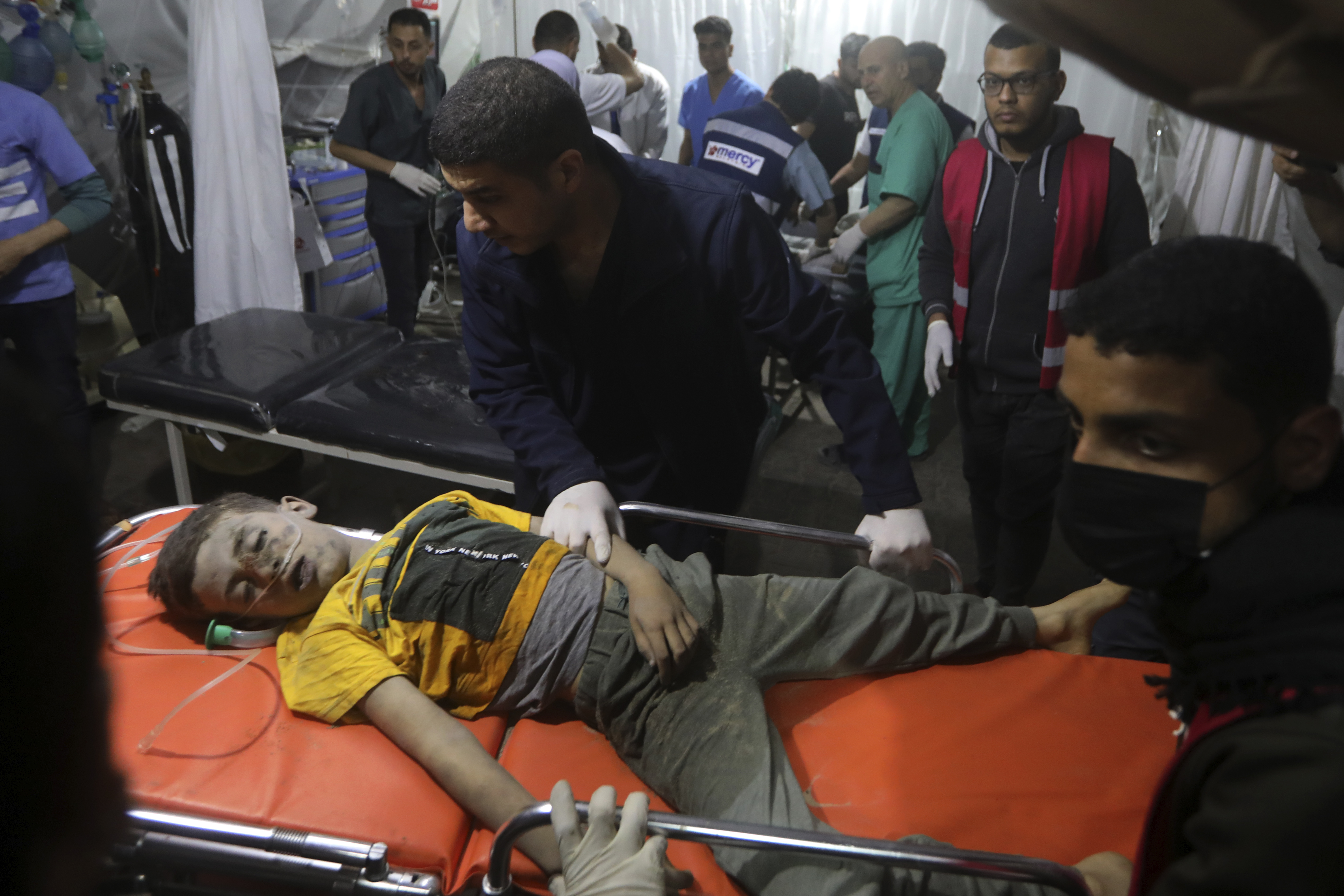EDS NOTE: GRAPHIC CONTENT - A Palestinian youth seriously wounded in the Israeli bombardment of the Gaza Strip is brought to the Kuwaiti Hospital in Rafah refugee camp, southern Gaza Strip, late Friday, April 19, 2024. (AP Photo/Ismael Abu Dayyah)