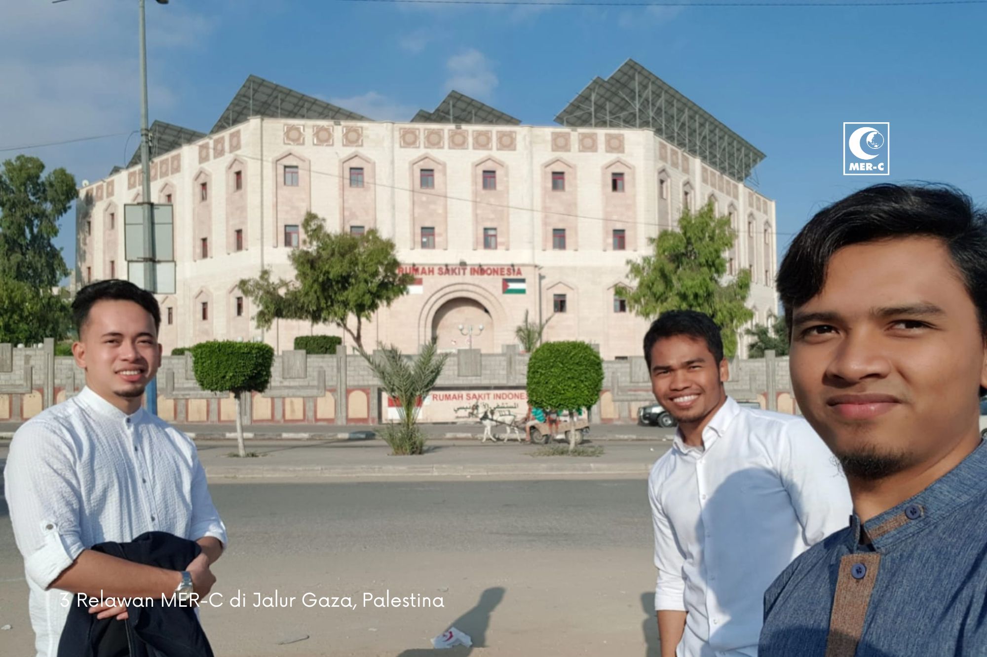 Fikri Rofiul Haq, left, is one of three Indonesia volunteers a the Indonesia Hospital in Gaza. The Indonesia Hospital is seen in the background during peacetime in the Palestinian enclave [Photo courtesy of MER-C]