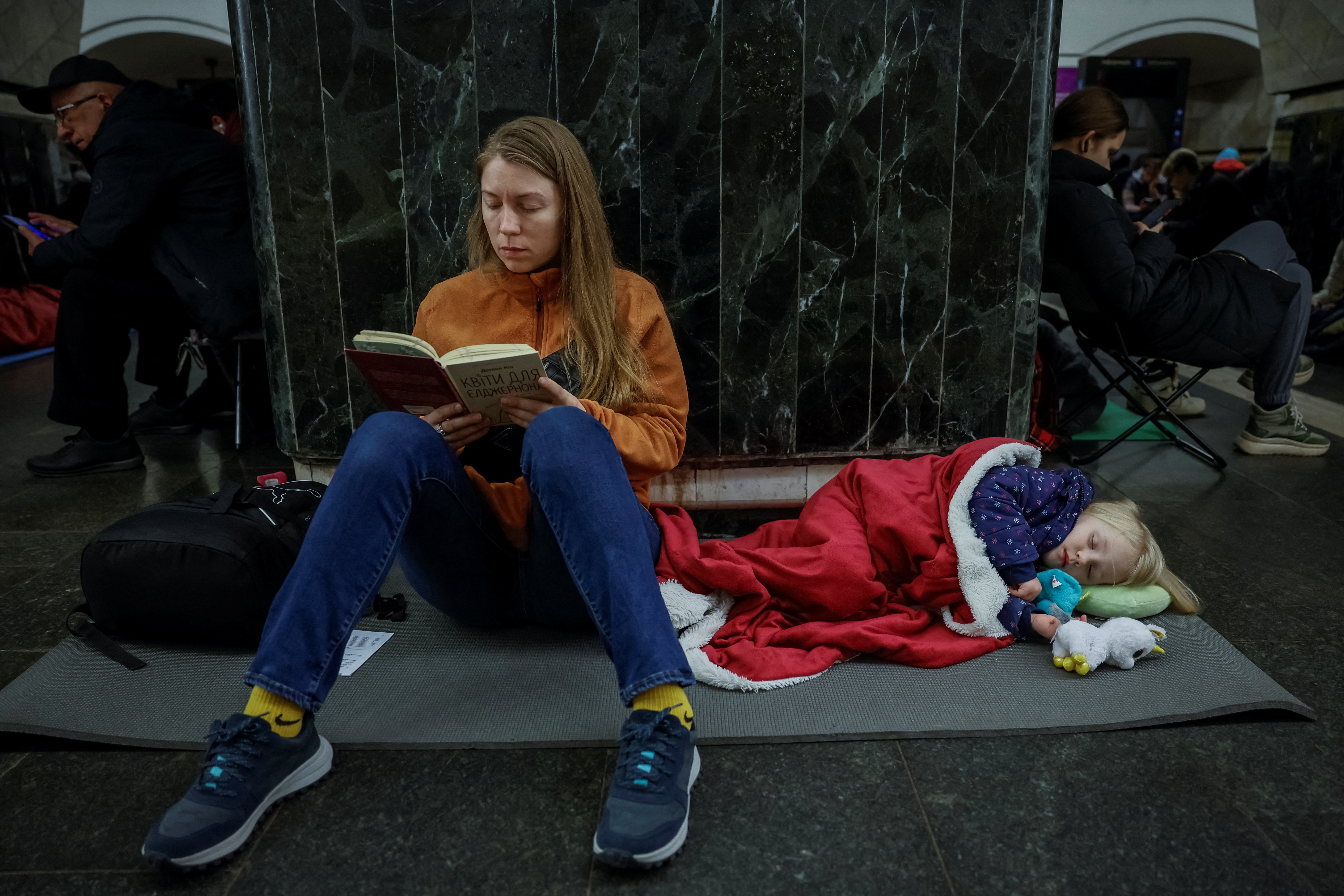 Yuliia takes shelter inside a metro station with her daughter Varvara during a Russian missile strike, amid Russia's attacks on Ukraine, in Kyiv, Ukraine, April 11, 2024. REUTERS/Alina Smutko