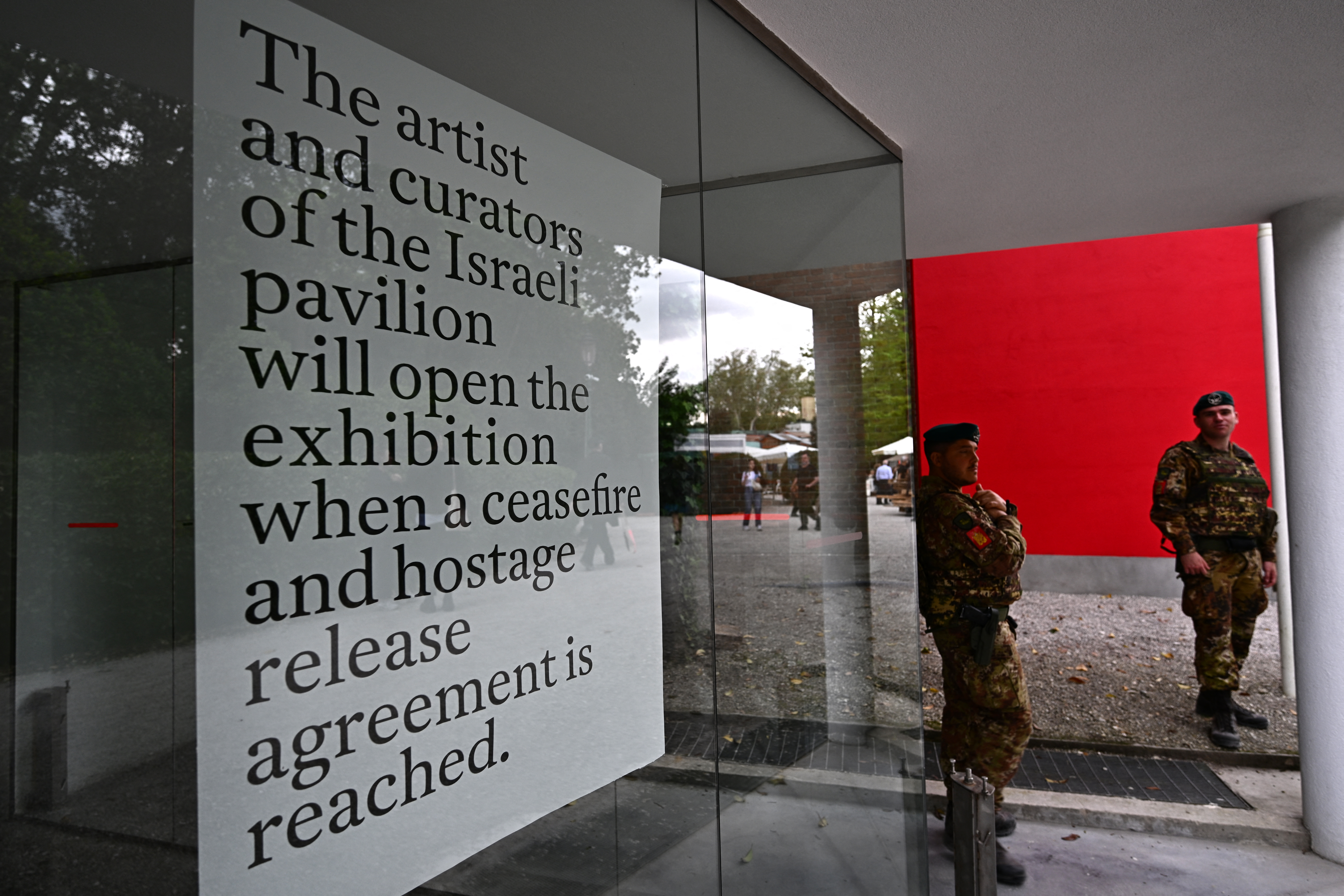 Italian soldiers stand guard in front of Israel's pavilion